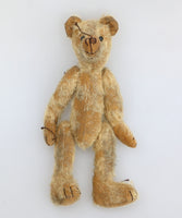 Slim Tim Tittlemouse is a scruffy and dishevelled traditional one of a kind artist bear in German mohair by Barbara Ann Bears  Slim Tim Tittlemouse is 11 inches/28 cm tall and is 7.5 inches/22 cm sitting.  Slim Tim Tittlemouse is a tribute to Little Tommy Tittlemouse who sits in the V&A Museum in London, although Slim Tim is twice the size of Little Tommy. He's been made to look very old and well loved, he might look grubby but he's a clean bear, he's just been rubbed with a soft sketching pencil. 