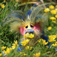 Sparky McTickle has beautiful, hand painted glass eyes with hand coloured eyelids, a splendid nose embroidered from individual threads to compliment his colouring and he has a huge, friendly smile. He loves wild flowers, in our garden he roams about sniffing the celandines