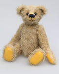 Thomas is a very sweet and charming, one of a kind, traditional artist teddy bear by Barbara Ann Bears. He stands 14 inches/36cm tall and is 10.5 inches/26 cm sitting and is made from a beautiful, distressed, fairly long and fluffy German mohair which is a very pale grey with some black threads woven into it.