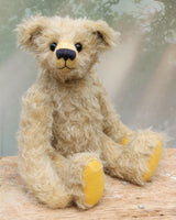 Thomas is a very sweet and charming, one of a kind, traditional artist teddy bear by Barbara Ann Bears. He stands 14 inches/36cm tall and is 10.5 inches/26 cm sitting and is made from a beautiful, distressed, fairly long and fluffy German mohair which is a very pale grey with some black threads woven into it.