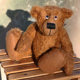 Tommy Tickle is an extremely happy, cute and friendly one of a kind mohair artist bear by Barbara Ann Bears, he stands 9.5 inches(24 cm) tall and is 7.5 inches (19 cm) sitting. Tommy Tickle is made from a medium length, wildly tousled brown German mohair with brown German wool felt paw pads, googly eyes and a big smile