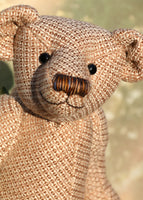 Tweedy is a an elegant and refined traditional Barbara Ann Bear made in a very dapper tweed from tweed maker Romney Tweed, he is 16 inches (38cm) tall and is 11 inches (30cm) sitting. Tweedy is made from tweed with a golden brown and creamy beige pattern his paw pads are tweed, in a brown, beige and blue tartan