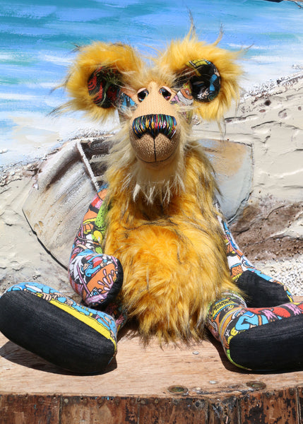 Wally is a magnificent, comical and joyful, one of a kind, artist bear by Barbara-Ann Bears in a printed cotton, mohair and faux fur, standing 23.5 inches (60 cm) tall and 18 inches (46 cm) sitting. Wally is mostly made from a 'Where's Wally?' fabric depicting a coastal town full of sailors being overrun by sea monsters