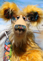 Wally is a magnificent, comical and joyful, one of a kind, artist bear by Barbara-Ann Bears in a printed cotton, mohair and faux fur, standing 23.5 inches (60 cm) tall and 18 inches (46 cm) sitting. Wally is mostly made from a 'Where's Wally?' fabric depicting a coastal town full of sailors being overrun by sea monsters