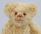 Walter is made from gorgeous dense, wavy, blonde German mohair and coordinating beige wool felt paw pads. Walter has gently coloured and painted eyes, a pert little nose carefully embroidered from a muted blend of brown and beige threads and the sweetest smile