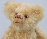 Walter is made from gorgeous dense, wavy, blonde German mohair and coordinating beige wool felt paw pads. Walter has gently coloured and painted eyes, a pert little nose carefully embroidered from a muted blend of brown and beige threads and the sweetest smile