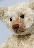 Warburton is a very sweet and loving classical, traditional mohair artist teddy bear by Barbara Ann Bears, he is 17 inches (43cm) tall and is 13 inches (33cm) sitting. Warburton is made from distressed creamy white mohair with beige wool felt paw pads, reproduction black boot button eyes and an embroidered brown nose