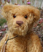 Wilfred is made from a wonderful antique gold mohair, it is a medium length, and a little fluffy and distressed, it's not a type of mohair that is made anymore which makes him just that little bit extra special. Wilfred has gorgeous amber glass eyes, a splendid, carefully embroidered brown nose and a relaxed and demure expression. Wilfred was the first of our bears to have a beard, we were about to trim it off but thought it rather suited him