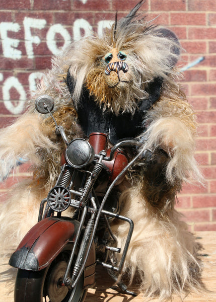 Wild Wyatt is a wild, freakishly fast and surprisingly friendly, one of a kind, mohair, artist,  biker bear by Barbara-Ann Bears. He is 11.5 inches (29 cm) tall sitting on his bike, sitting without a bike he is 10 inches (25 cm) tall and his model Indian Chief bike is 14.5 inches (36 cm) long.