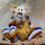 Zebedee is a very shaggy, stripy and colourful, one of a kind, artist teddy bear, he is quite a large and heavy teddy bear, he stands 18.5 inches (47 cm) tall and is 14.5 inches (37 cm) sitting.  Zebedee is made from faux fur in bands of white, magenta, sunny orange and royal blue with white mohair and  orange faux fur