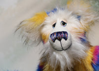 Zebedee has large, beautiful, hand painted glass eyes with hand coloured eyelids, he has a carefully embroidered nose that incorporates all of his colours and a sweet, thoughtful smile