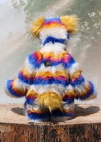 Zebedee is mostly made from a fairly long, soft and dense faux fur in bands of white, magenta, sunny orange and royal blue. Zebedee's face and the fronts of his ears are made from a very long and soft white mohair and his tummy and the underside of his tail made from a very long sunny orange faux fur with some black tipping. As you can see in the photos Barbara has cut out his pattern so that the stripes match all the way around his body, arms and legs.